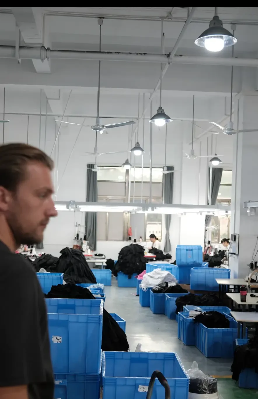 Frank walking through an active garment production floor
